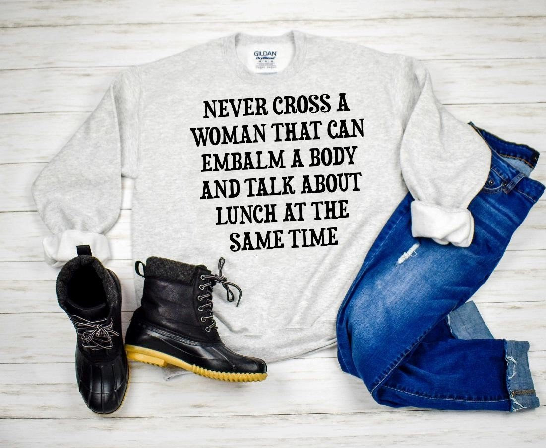 Never Cross A Woman That Can Embalm Body And Talk Lunch At The Same Time Graphic Tee Graphic Tee